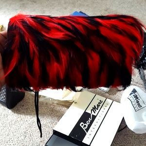 Black clutch with red and black feathers